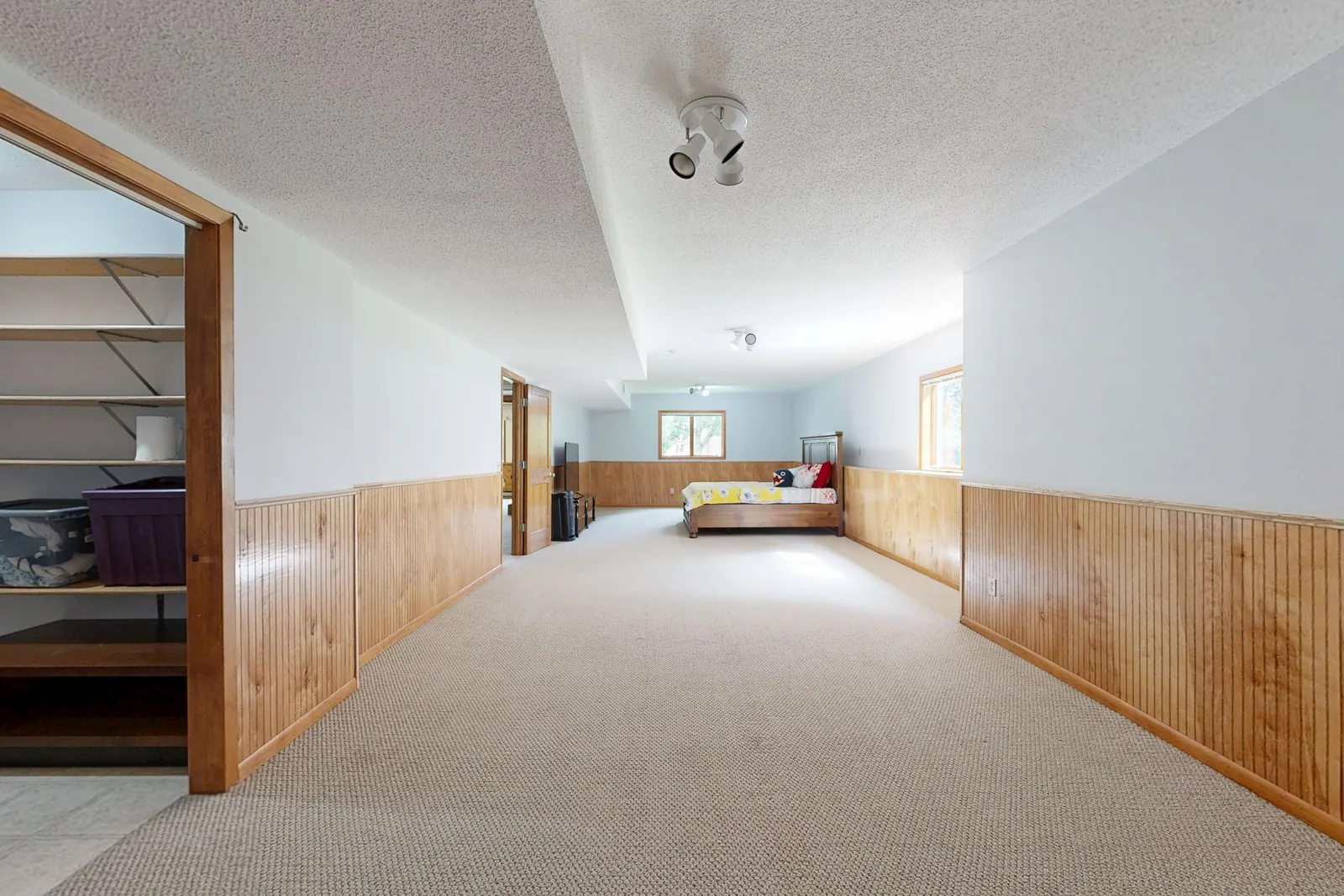A dated basement with wood panel wainscoting